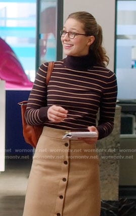 Kara's striped turtleneck sweater and camel button-front skirt on Supergirl