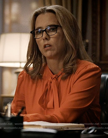 Elizabeth's orange tie-neck blouse on Madam Secretary