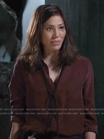 Angela's burgundy blouse with black tie neck on Bones