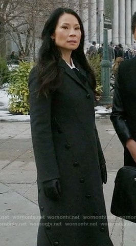 Joan's long black coat with asymmetrical buttons on Elementary