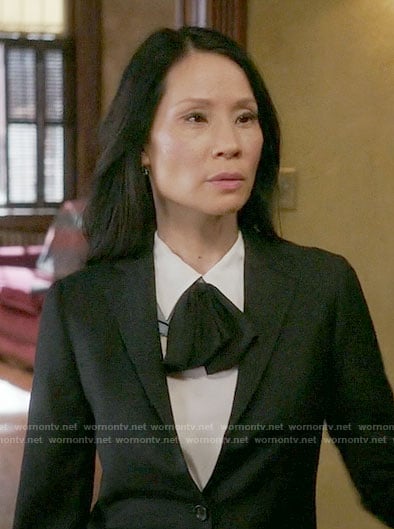 Joan's white top with black tie neck on Elementary