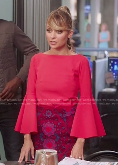 Portia's red bell sleeve top and lace skirt on Great News