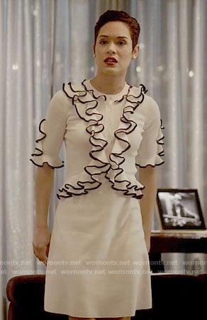 Anika's white ruffled dress with black trim on Empire