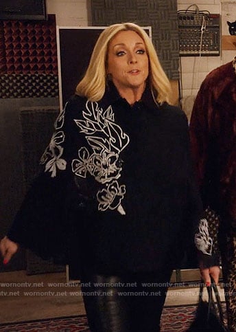 Jacqueline's black cape with white floral embroidery on Unbreakable Kimmy Schmidt