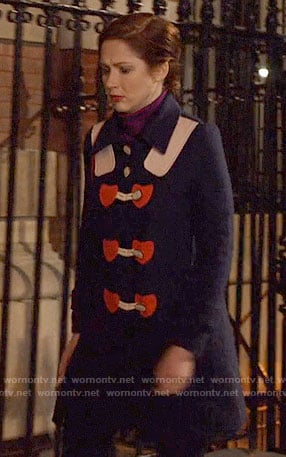 Kimmy's navy coat with red hearts on Unbreakable Kimmy Schmidt