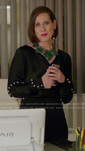 Diana's black pearl embellished top and green necklace on Younger