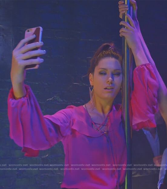 Katie's pink ruffled lace-up top on Great News
