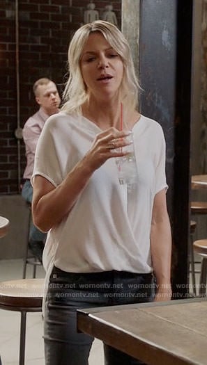 Mickey's white draped button front top on The Mick