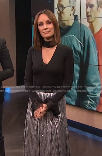 Catt's black choker neck top with lace cuffs and sequin pleated skirt on E! News