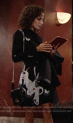 Lily's black bird and butterfly print dress on The Reformation