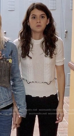 Sabrina's white ruffle trim top on The Mick