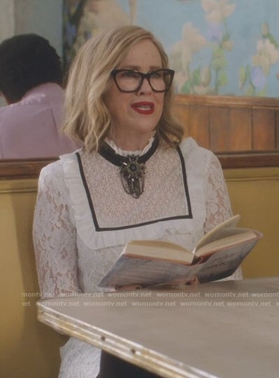 Moira's white bib front lace dress on Schitt's Creek