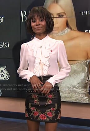 Zuri's white ruffled blouse and floral mini skirt on E! News