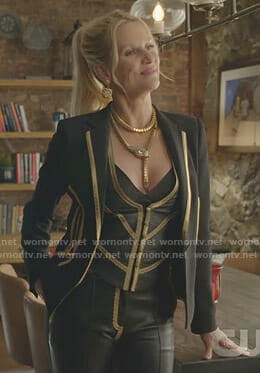 Alexis'w black jacket with gold trim and leather trousers on Dynasty