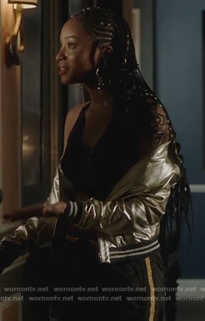 Tangey's metallic bomber jacket and stripe black pants on Famous in Love