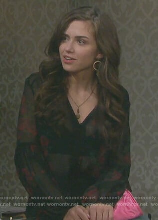 Ciara's black rose print top and jeans with side bows on Days of our Lives