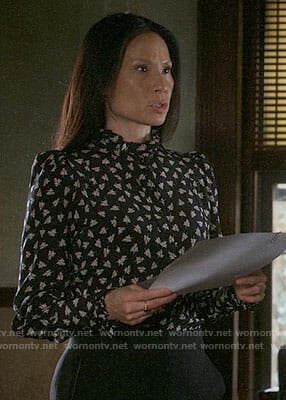 Joan's black leaf print blouse on Elementary