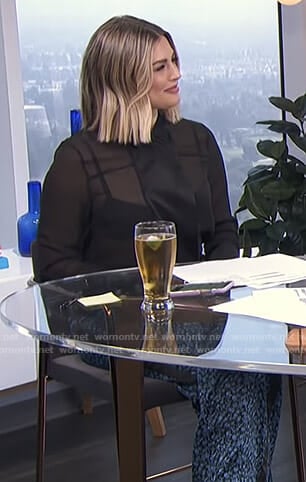 Carissa's black sheer blouse and printed pants on E! News Daily Pop