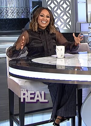 Tamera's black sheer blouse and striped trousers on The Real