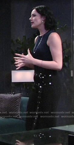 Tessa's navy top and black double belted pants on The Young and the Restless