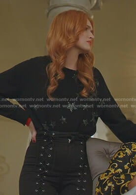 Kirby's black star print sweater and  lace-up pants on Dynasty