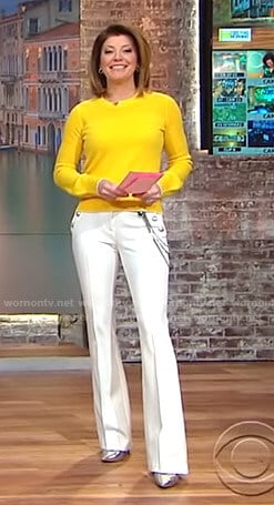 Norah's yellow sweater and white chain detail pants on CBS This Morning