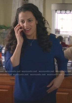 Grace's blue button-sleeve top on Manifest