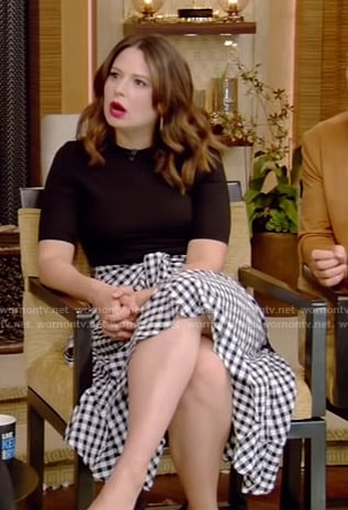 Katie Lowes's black top and gingham check skirt on Live with Kelly and Ryan