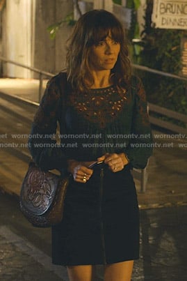 Judy's navy cutout top with contrast stitching on Dead to Me