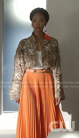 Monica's camo cropped jacket and orange pleated skirt on Dynasty