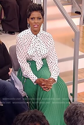 Tamron's white polka dot blouse and green pleated skirt on Tamron Hall Show