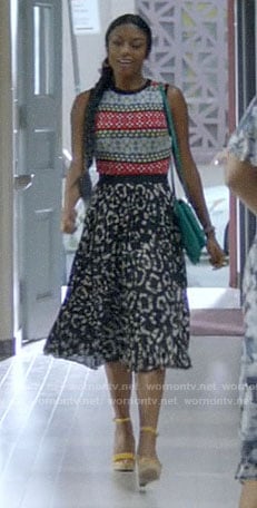 Ali's printed sleeveless top and black leopard skirt on God Friended Me