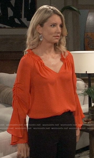 Nina's orange ruffle neck blouse on General Hospital