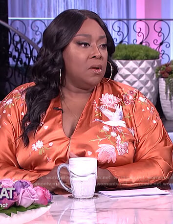 Loni's orange embroidered wrap dress on The Real