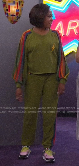 Tina's green sweatshirt with rainbow striped sleeves on The Neighborhood
