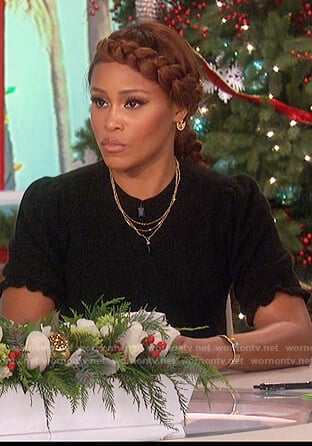 Eve's black ruffle trim sweater and skirt on The Talk