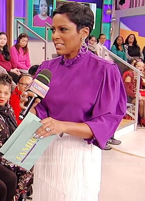 Tamron's purple blouse and fringe skirt on Tamron Hall Show