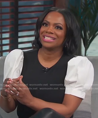 Kandi Burruss's black and white puff sleeve top on Access Hollywood
