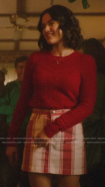 Katy's red cable knit sweater and striped skirt on Katy Keene
