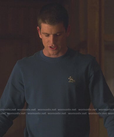 Guzman's teal Lacoste sweatshirt on Elite