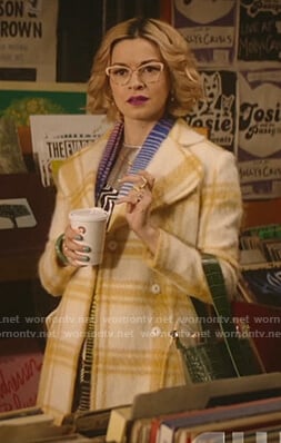 Pepper's zebra print dress and white and yellow plaid coat on Katy Keene