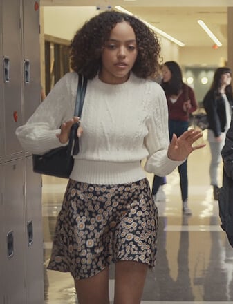 Tabitha's white cable knit sweater and floral skirt on Trinkets