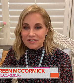 Maureen McCormick's black floral smocked neck blouse on Today