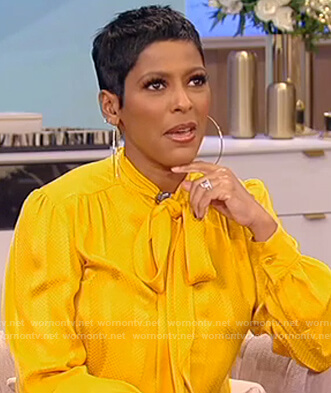 Tamron's yellow satin tie neck blouse on Tamron Hall Show