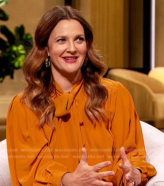 Drew's orange tie neck blouse on The Drew Barrymore Show
