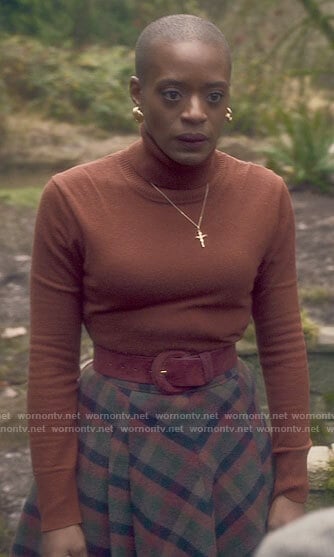 Hannah's orange turtleneck and checked skirt on The Haunting of Bly Manor