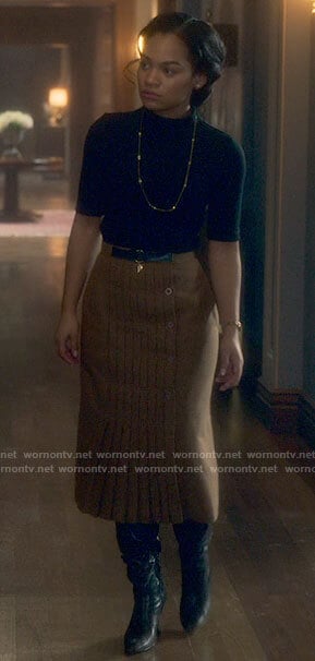 Rebecca's black top and pleated camel skirt on The Haunting of Bly Manor