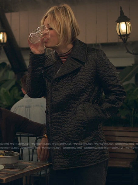 Cassie's black crocodile textured coat on The Flight Attendant