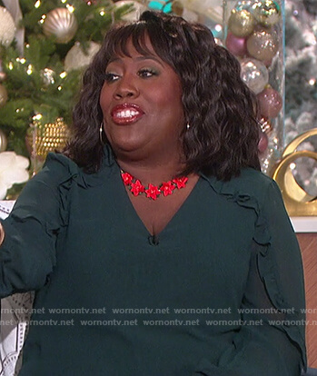 Sheryl's green ruffle blouse and necklace on The Talk