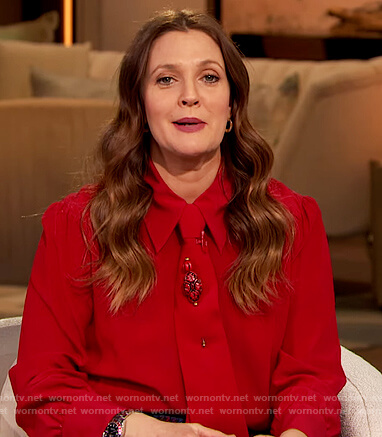 Drew's red tie neck blouse and plaid pants on The Drew Barrymore Show